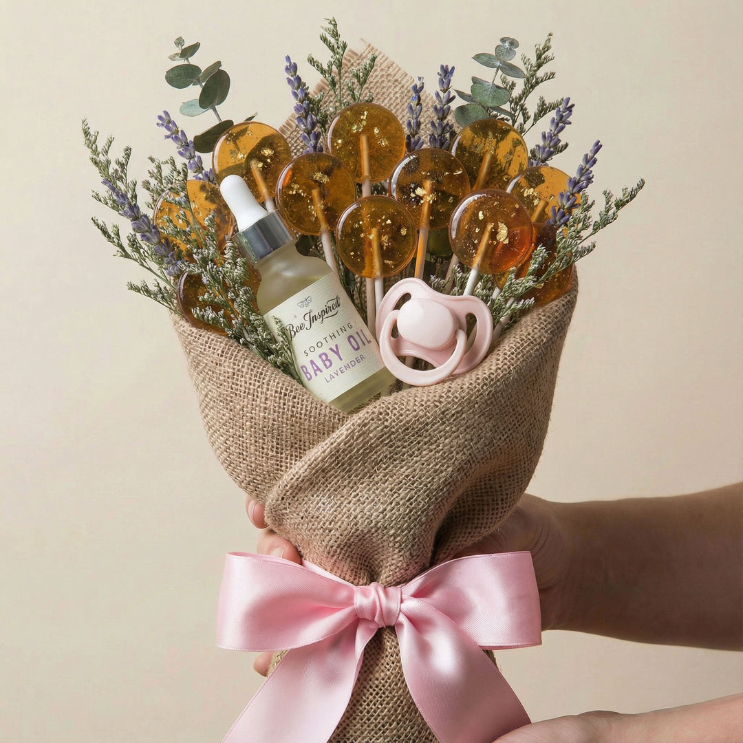 Bouquet with baby items including a bottle, pacifier, and flowers on a beige background