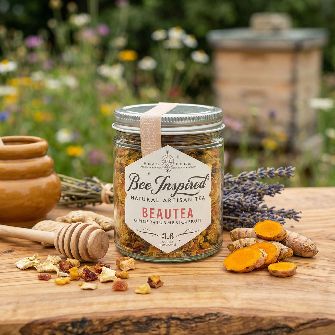 Jar of 'Bee Inspired' natural artisan tea with ingredients on a wooden surface outdoors.