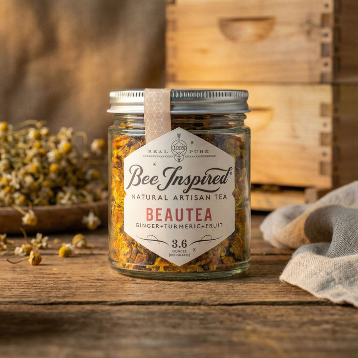 Jar of 'Bee Inspired' Beautea tea on a wooden surface with a rustic background