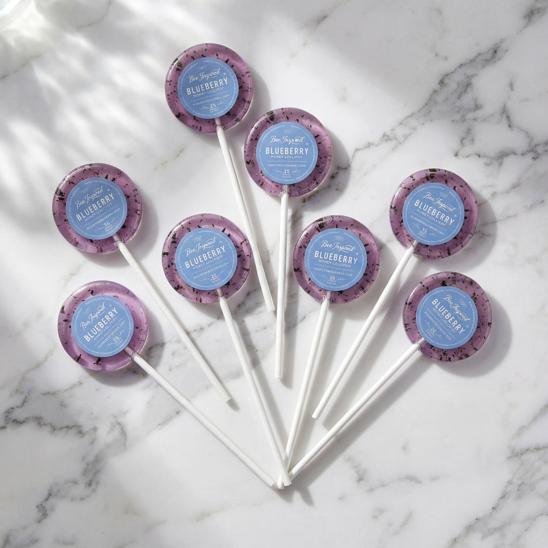 Blueberry-flavored lollipops on a marble surface