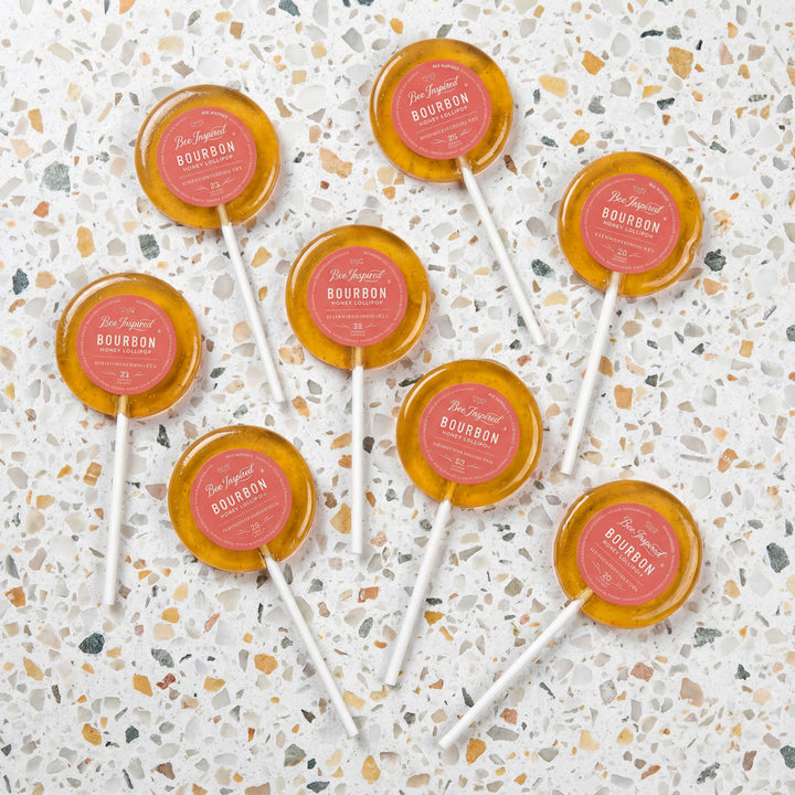 Lollipops with pink labels on a terrazzo countertop