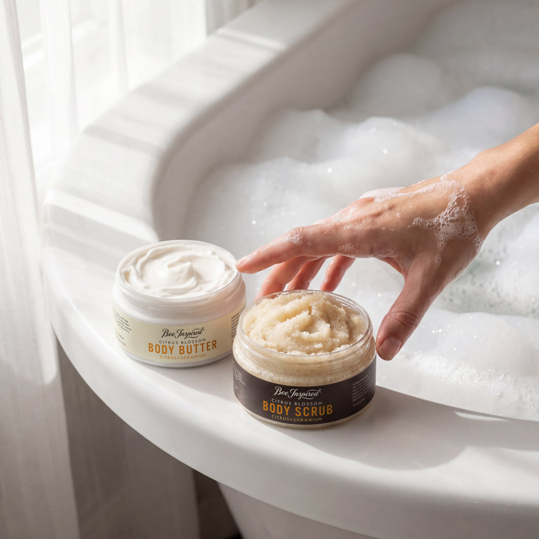 Two jars of body products on a bathtub rim with a hand reaching for one jar.