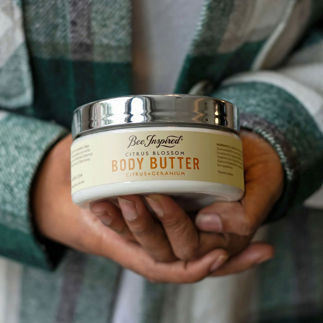 Person holding a jar of Bee Inspired Citrus Blossom Body Butter
