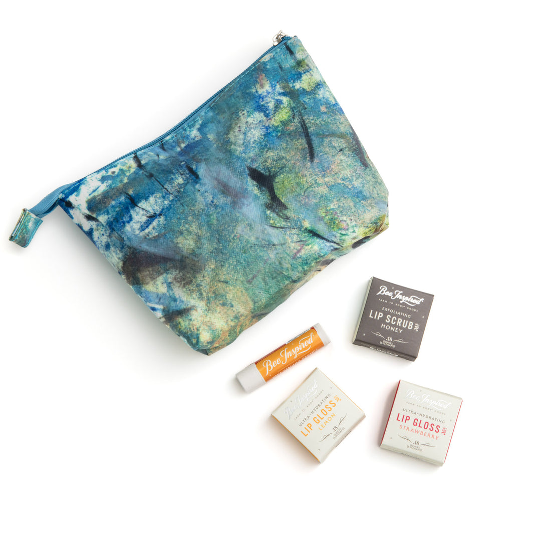 Cosmetic pouch with lip products on a white background