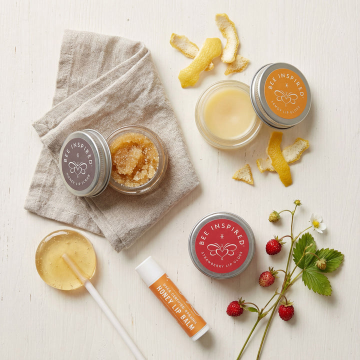 Bee-inspired skincare products on a light surface with natural elements.