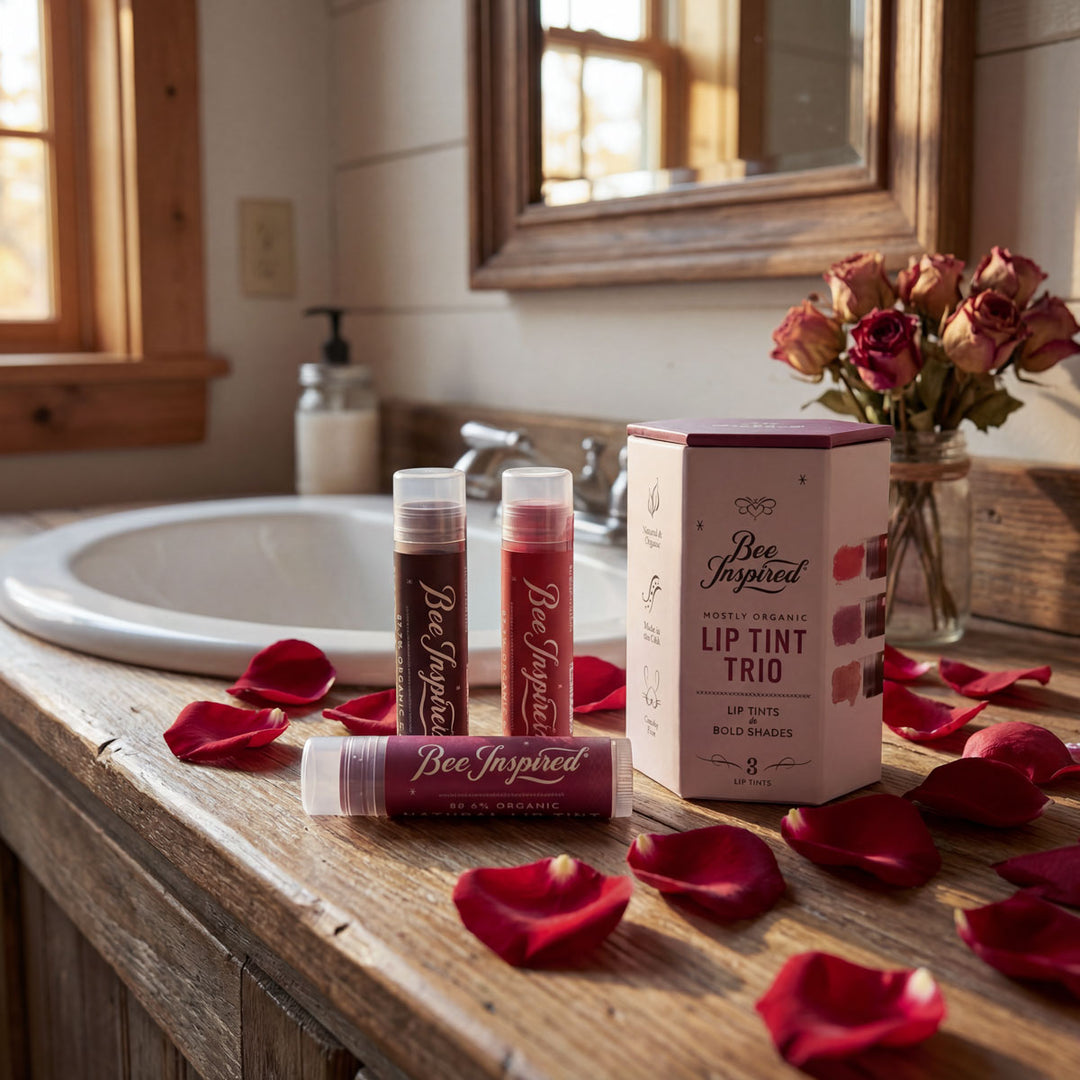 Bee Inspired lip tint products on a bathroom counter with rose petals