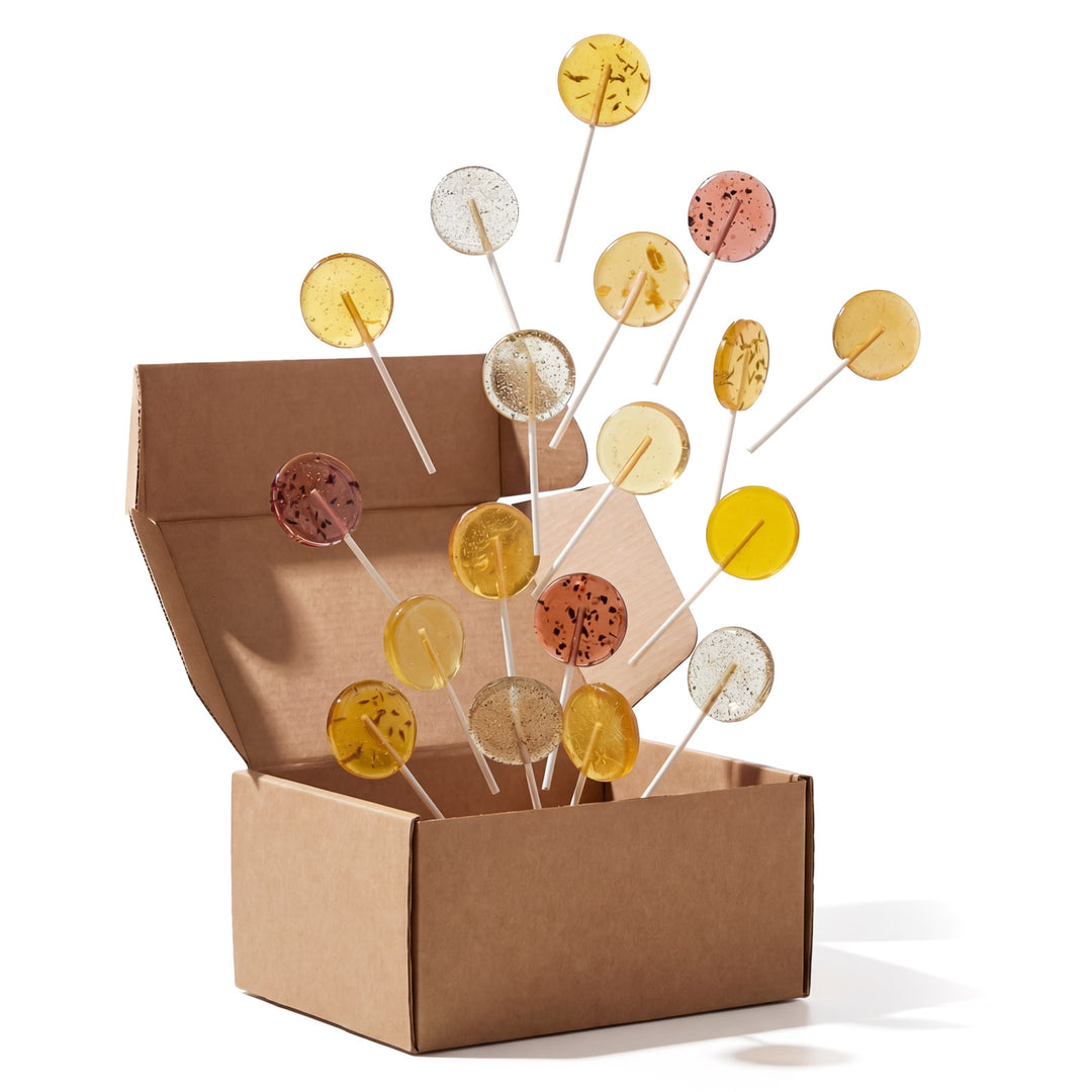 Open brown box with colorful lollipops on sticks spilling out.